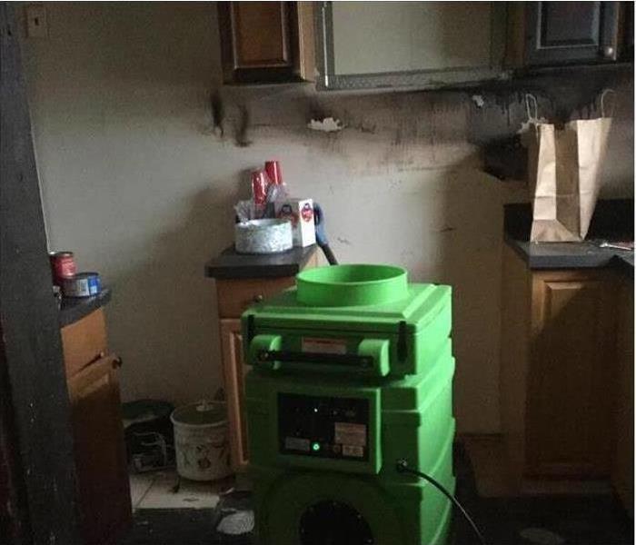 An scrubber sitting inside this kitchen after a fire